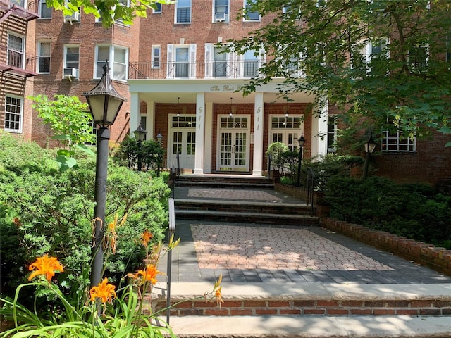 511 W 232nd St Unit E56, Bronx, NY 10463 - property entrance featuring french doors, brick siding, and a porch