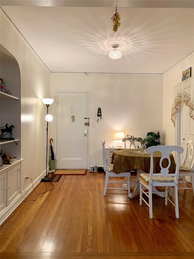 511 W 232nd St Unit E56, Bronx, NY 10463 - dining area with light wood-style flooring, a chandelier, and arched walkways