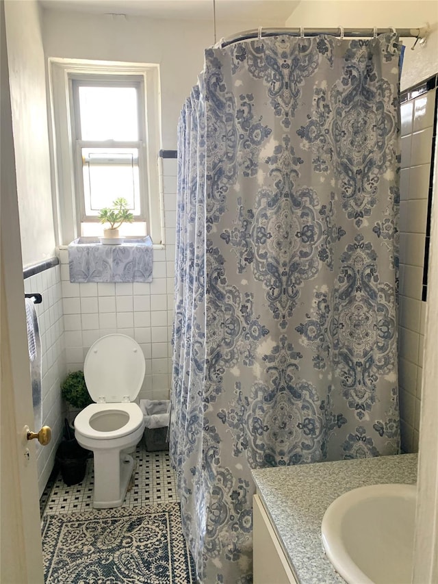 511 W 232nd St Unit E56, Bronx, NY 10463 - bathroom with vanity, tile walls, tile patterned flooring, wainscoting, and a shower with shower curtain