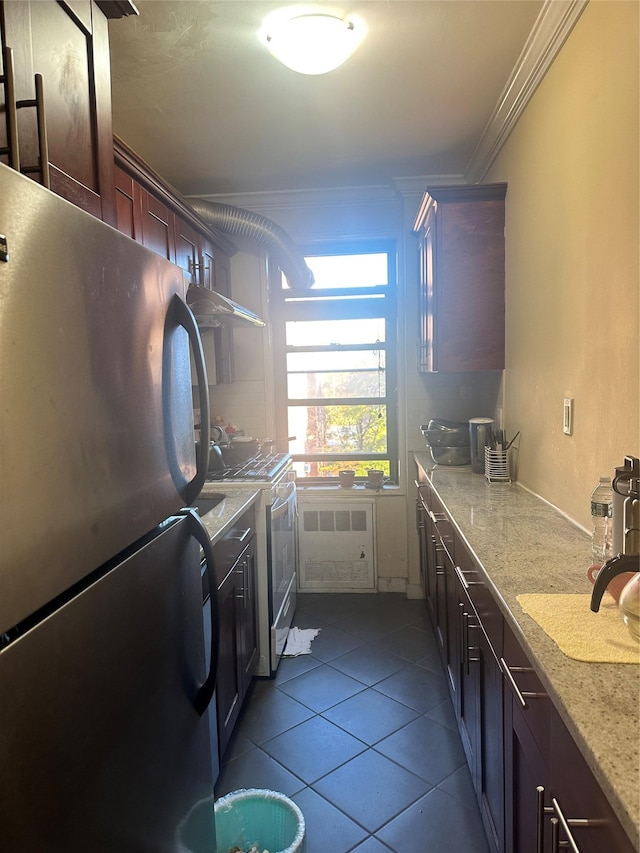 150-30 71st Ave Unit 4F, Kew Garden Hills, NY 11367 - laundry room with ornamental molding and dark tile patterned flooring