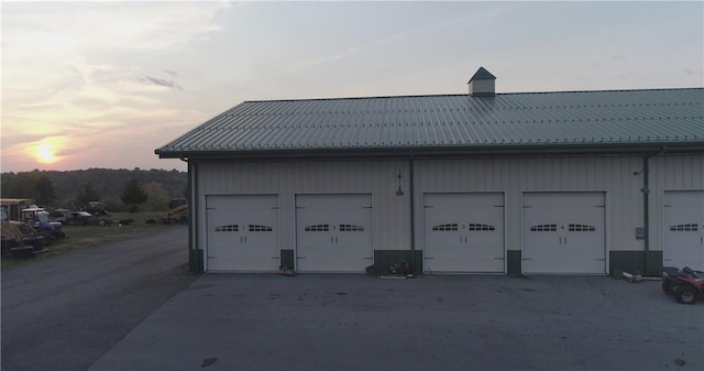 view of garage at dusk