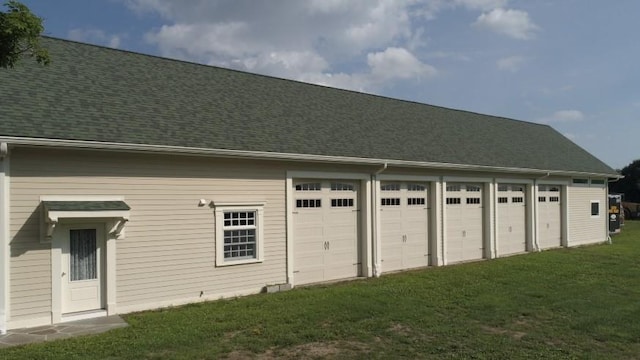 garage featuring a lawn