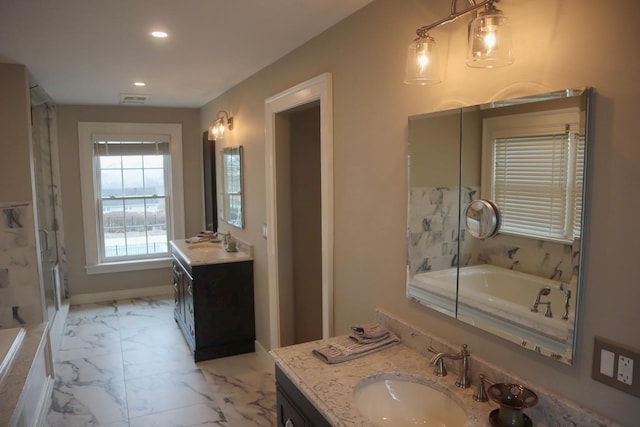 bathroom featuring vanity and shower with separate bathtub