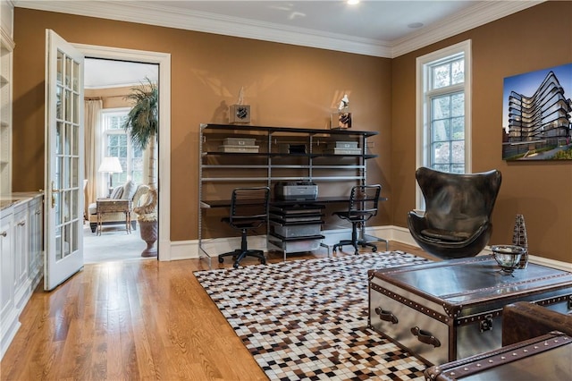 living area with french doors, light hardwood / wood-style floors, plenty of natural light, and crown molding