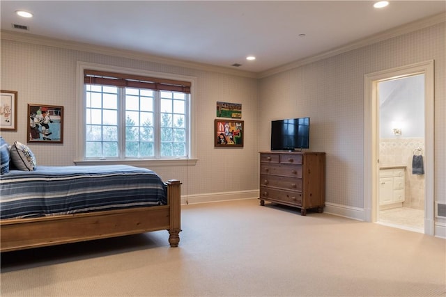 bedroom with ensuite bath, light carpet, and crown molding