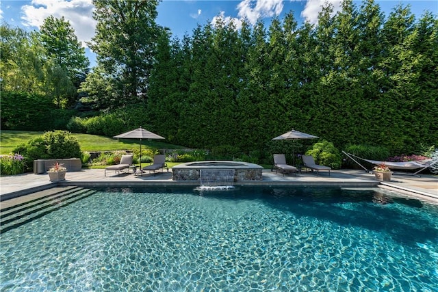 view of pool with a patio area and an in ground hot tub