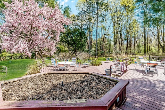 wooden terrace with a yard