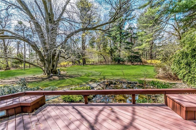 wooden terrace with a lawn