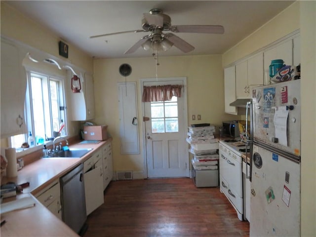 kitchen featuring appliances with stainless steel finishes, dark hardwood / wood-style flooring, ceiling fan, sink, and white cabinetry