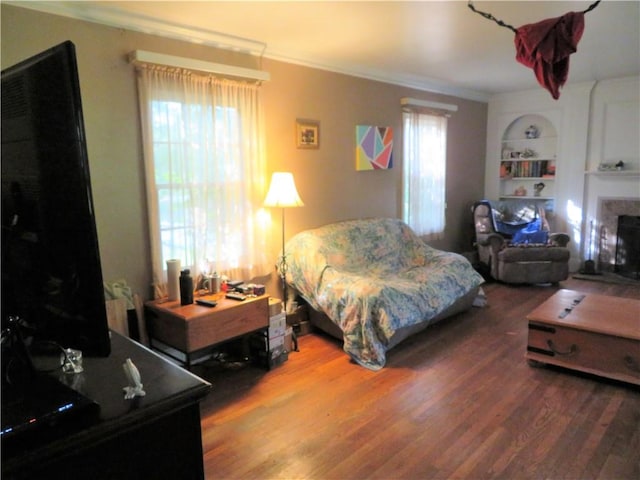 bedroom with hardwood / wood-style flooring and crown molding