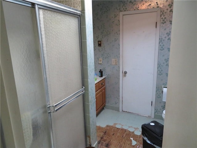 bathroom with vanity, toilet, and walk in shower