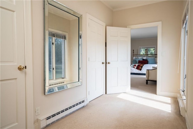 hallway with crown molding, light colored carpet, and a baseboard heating unit