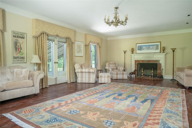 living room with a notable chandelier, dark hardwood / wood-style floors, crown molding, and a high end fireplace