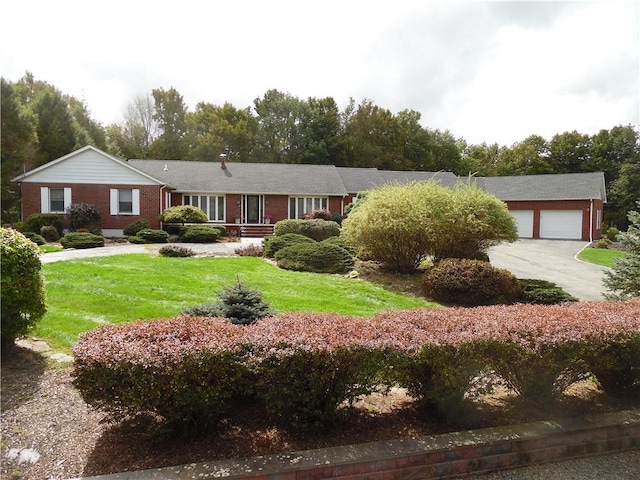 single story home with a garage and a front lawn