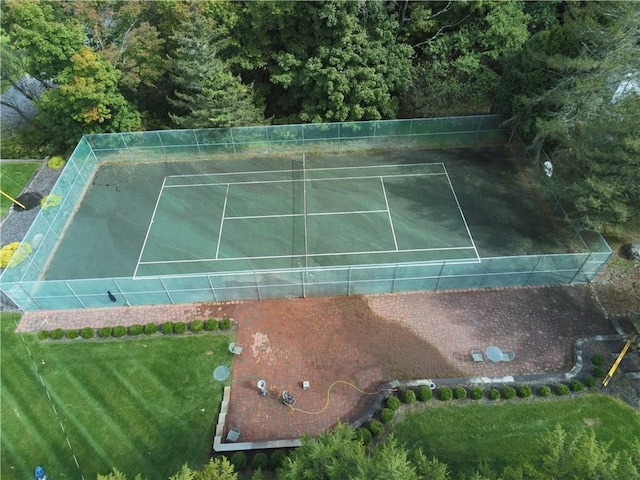 view of sport court featuring a yard