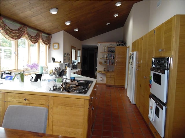 kitchen featuring white appliances, vaulted ceiling, dark tile patterned floors, and wood ceiling