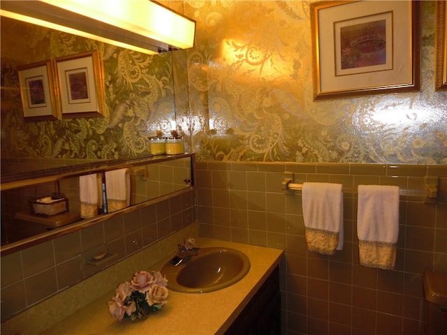 bathroom with vanity and tile walls