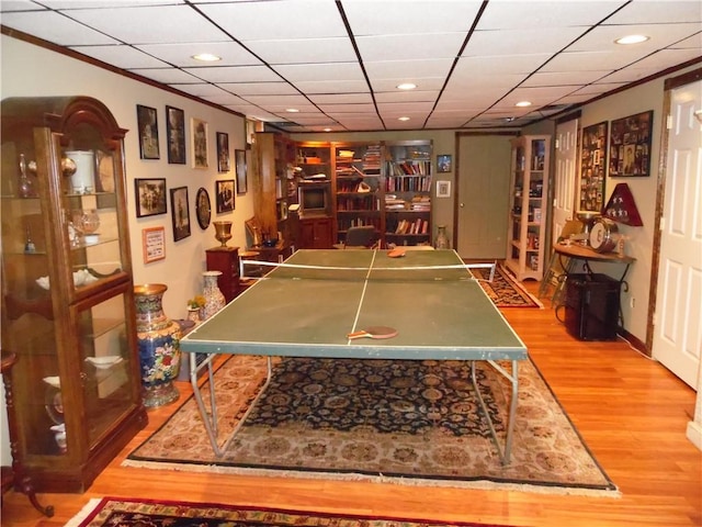 playroom with a drop ceiling and light wood-type flooring