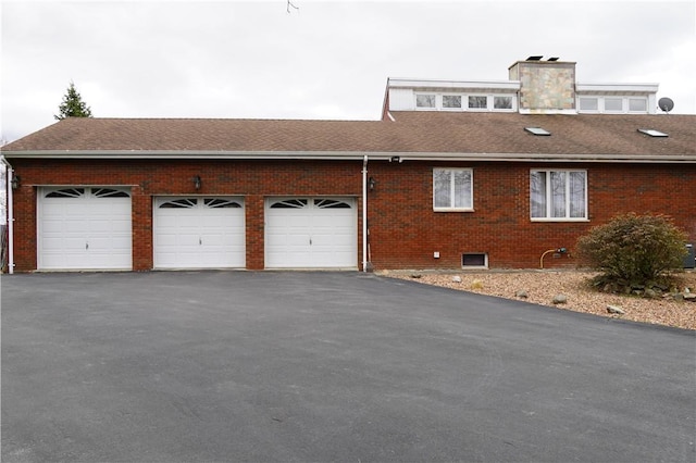 view of side of home featuring a garage