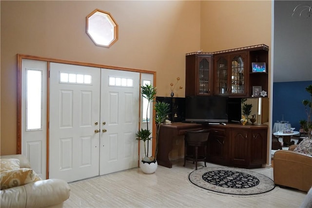 foyer entrance featuring a towering ceiling