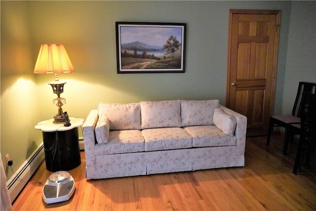 living room featuring a baseboard radiator and hardwood / wood-style flooring