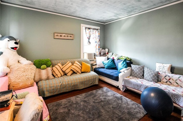 living room featuring cooling unit, dark hardwood / wood-style flooring, and crown molding