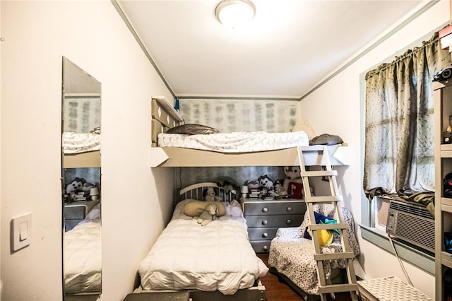 bedroom featuring hardwood / wood-style floors and ornamental molding