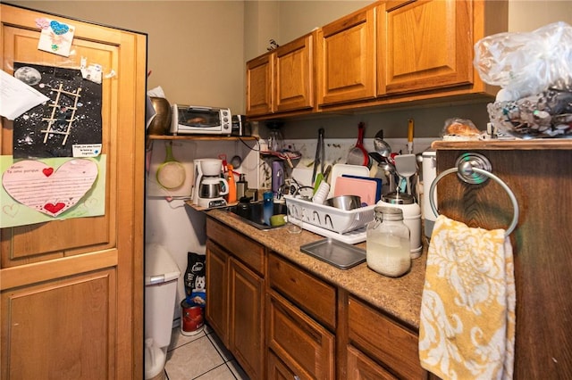 kitchen featuring light stone counters and light tile patterned flooring