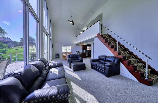 living room with carpet flooring and high vaulted ceiling