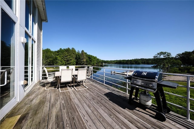 wooden deck with grilling area and a water view