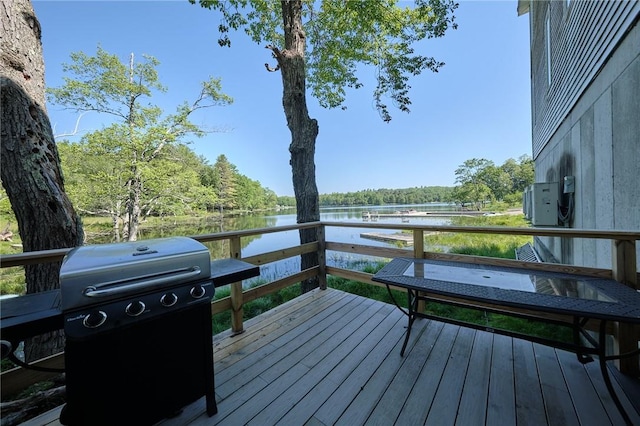 deck with grilling area and a water view