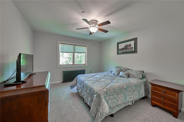 bedroom with radiator, ceiling fan, and light colored carpet