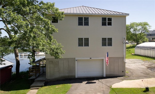 rear view of house featuring a garage