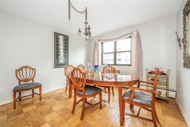 dining space featuring a notable chandelier and a baseboard heating unit