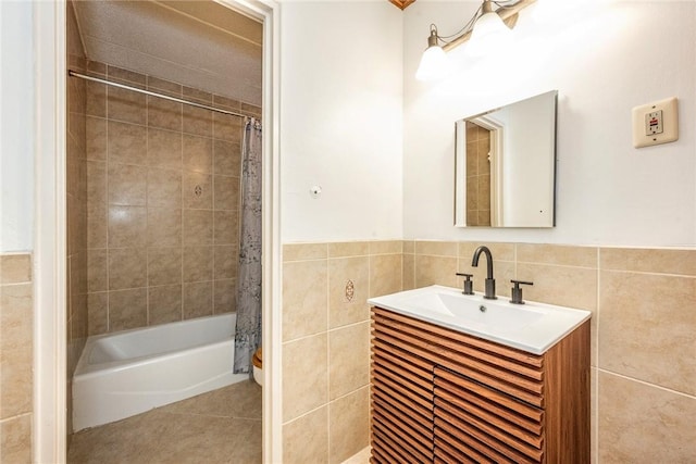 bathroom featuring vanity, shower / bath combination with curtain, and tile walls