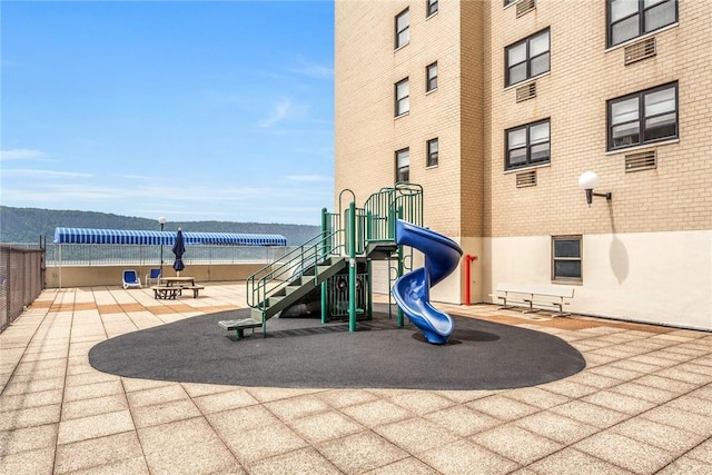 view of jungle gym featuring a mountain view