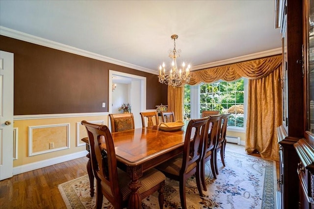 10 Evergreen Ct, Suffern, NY 10901 - dining space featuring a chandelier, baseboard heating, crown molding, wainscoting, and wood finished floors