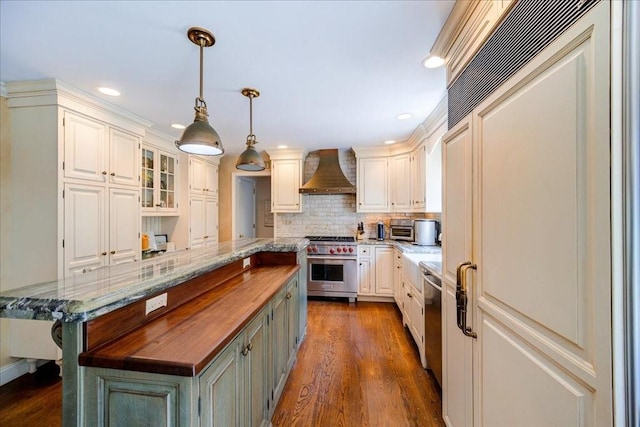10 Evergreen Ct, Suffern, NY 10901 - kitchen featuring wall chimney range hood, premium appliances, a kitchen island, tasteful backsplash, and butcher block countertops