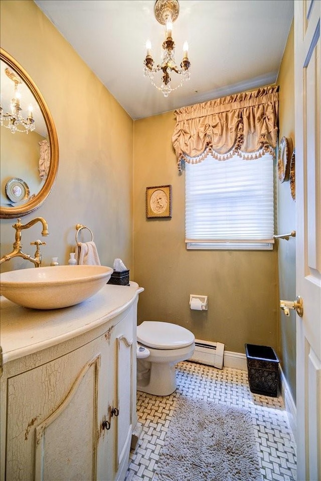 10 Evergreen Ct, Suffern, NY 10901 - half bath featuring a chandelier, a baseboard radiator, toilet, and vanity