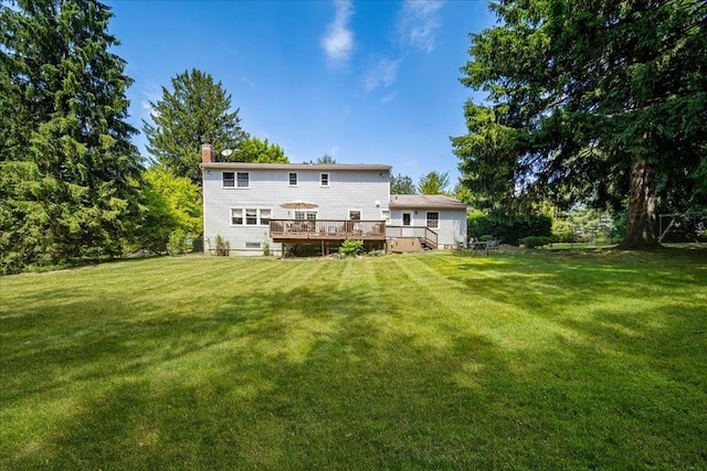 10 Evergreen Ct, Suffern, NY 10901 - rear view of house with a deck, a chimney, and a yard