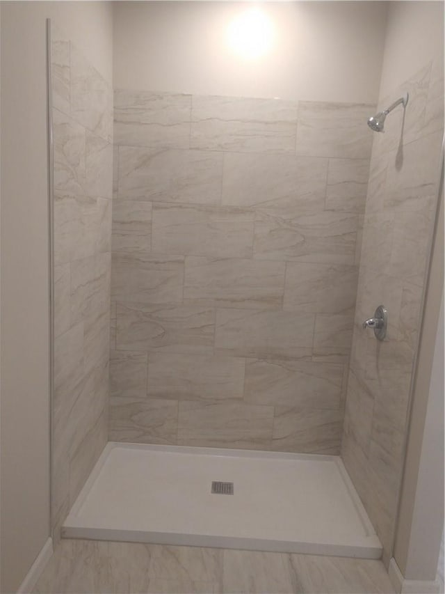 bathroom with tiled shower