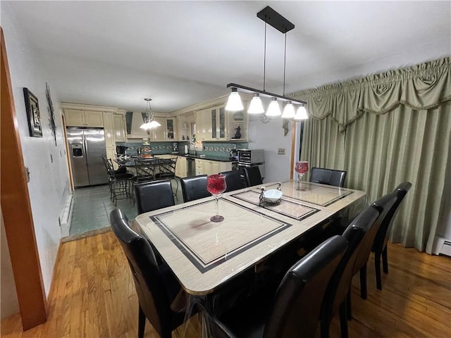 dining space with hardwood / wood-style floors