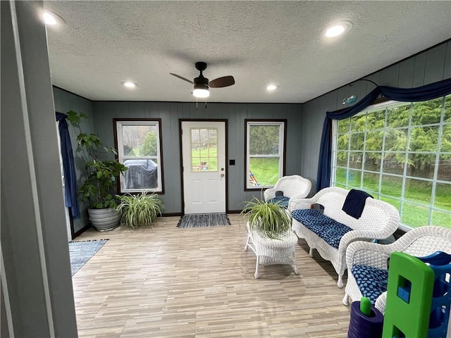 sunroom / solarium featuring ceiling fan