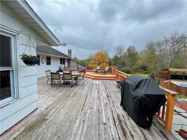 wooden terrace with a grill