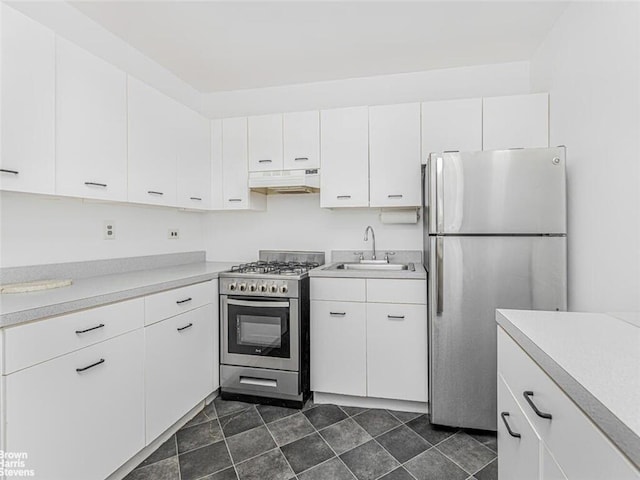 kitchen with stainless steel appliances, white cabinetry, and sink