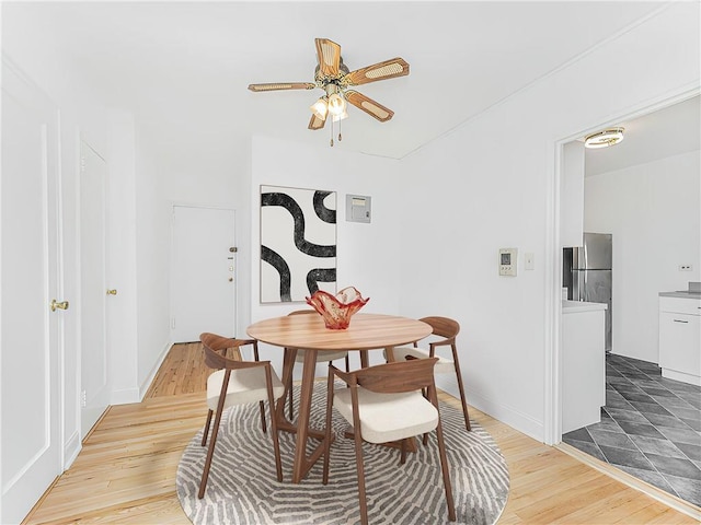 dining space with ceiling fan and hardwood / wood-style flooring