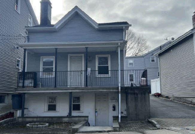 view of front of house with a balcony