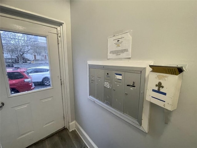 entryway with a mail area and dark wood-type flooring