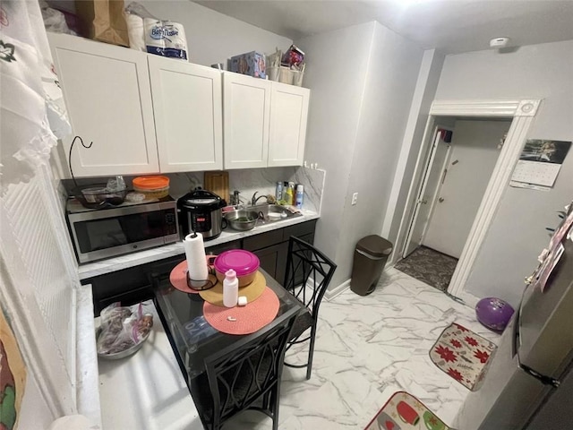 kitchen featuring sink and white cabinets