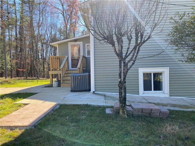 exterior space featuring cooling unit, a patio area, and a yard